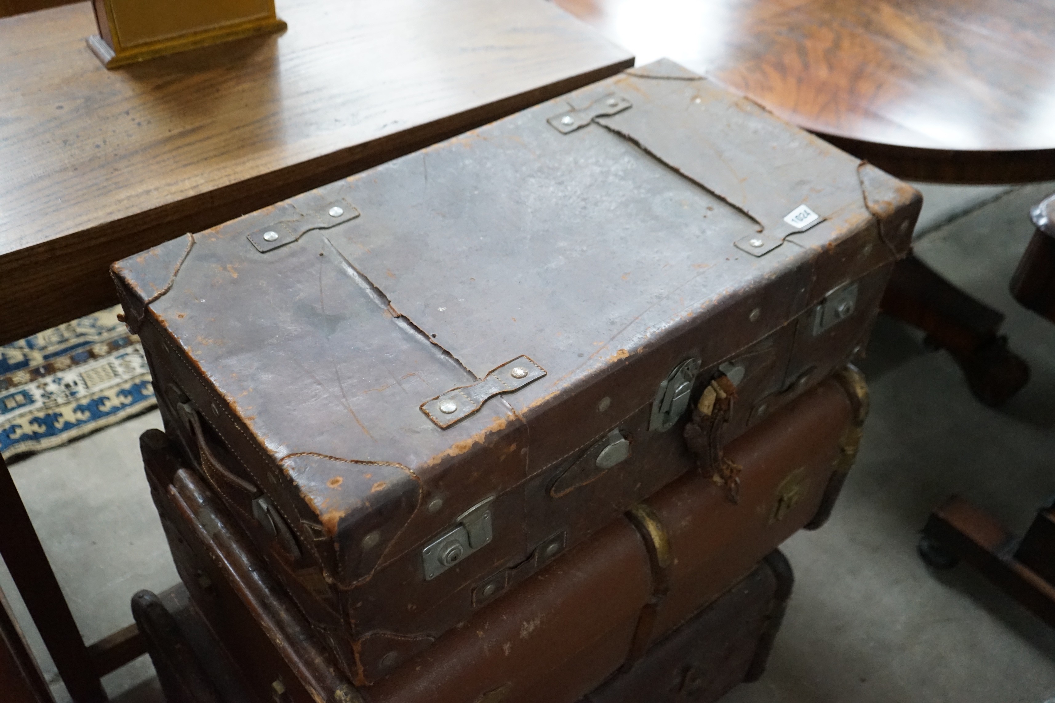 Three vintage suitcases, largest width 75cm